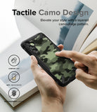 Galaxy A14 Case | Fusion-X - Hands holding a phone with a green camouflage case, featuring icons for grip and coating.