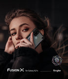Galaxy A21s Case | Fusion-X - Woman holding a Galaxy A21s in a black Fusion-X protective case against her cheek.