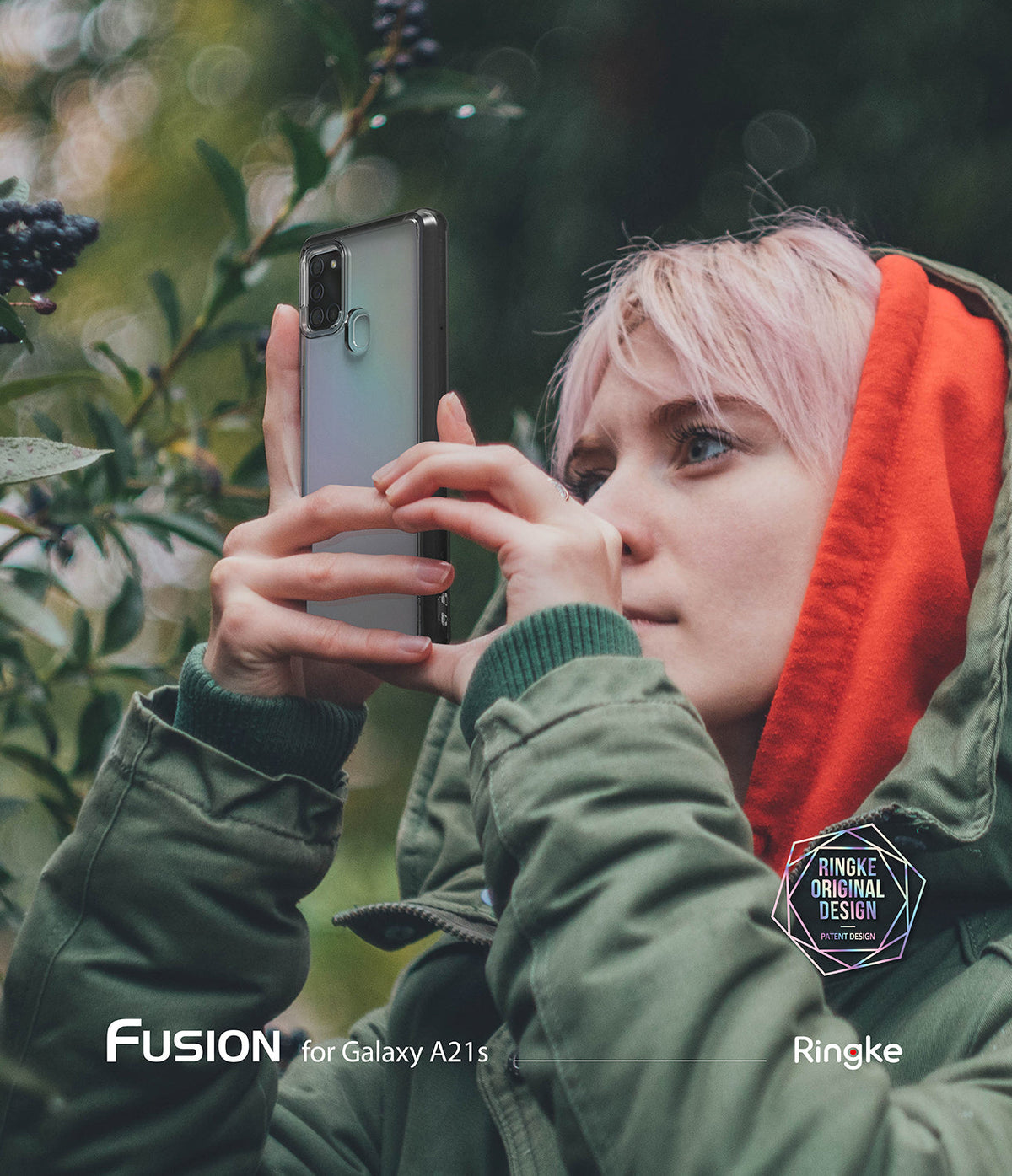Galaxy A21s Case | Fusion - Person with pink hair in a green jacket holding a phone with a clear case outdoors.