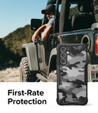 Galaxy A54 Case | Fusion-X - Black and white camo phone case with rugged bumpers shown next to a person in an off-road vehicle.