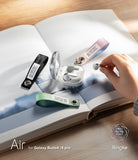 Galaxy Buds 4 Pro / 4 Case | Air - Clear charging case with colorful fabric straps on an open book, hand holding a bud.