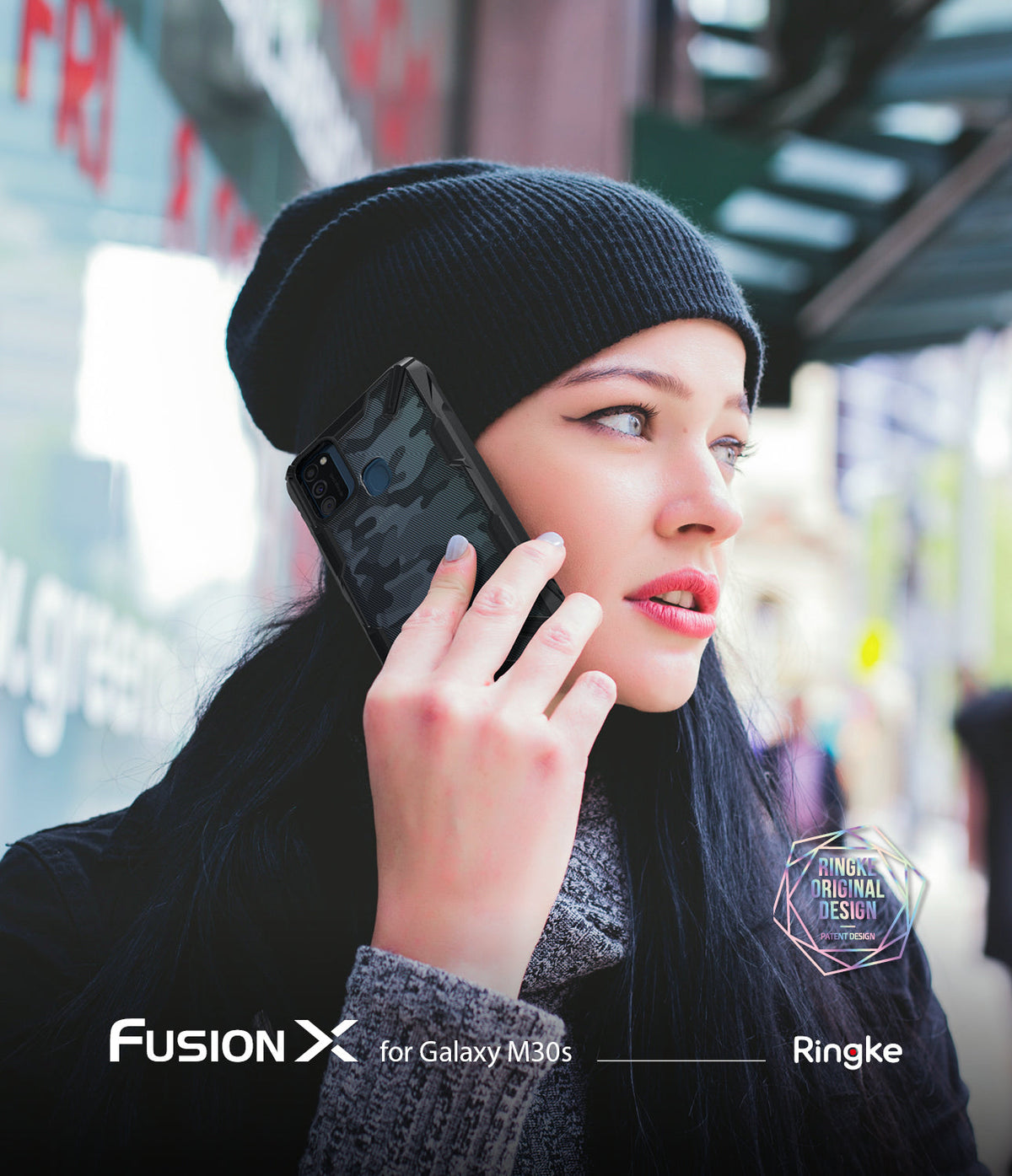Galaxy M30S / M21 Case | Fusion-X - Woman in a beanie holding a black camouflage-patterned phone case to her ear.