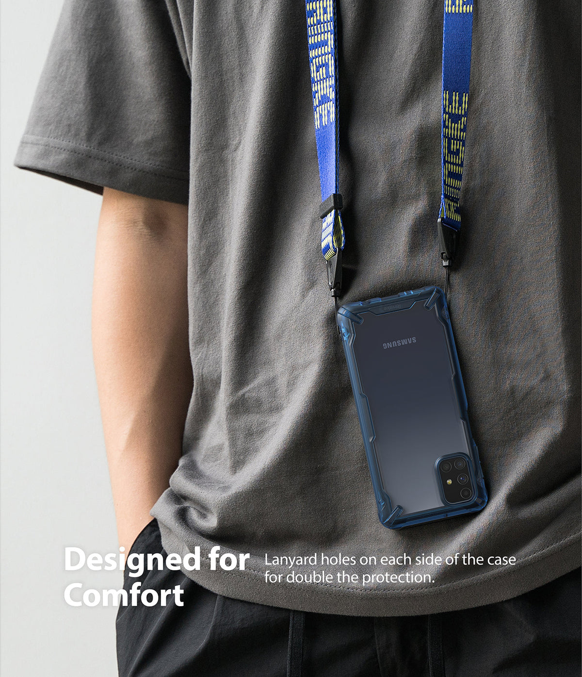 Galaxy M31s Case | Fusion-X - A blue phone case worn around the neck with a branded blue lanyard against a grey t-shirt.