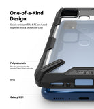 Galaxy M31 Case | Fusion-X - Close-up of a clear protective phone case with black shock-resistant bumpers on a blue Galaxy M31.