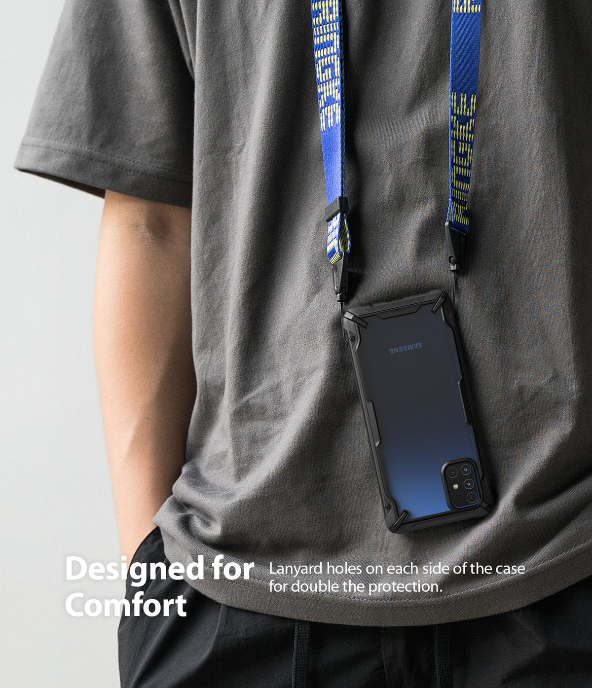 Galaxy M51 Case | Fusion-X - A phone in a black protective case hanging from a blue neck lanyard against a gray shirt.