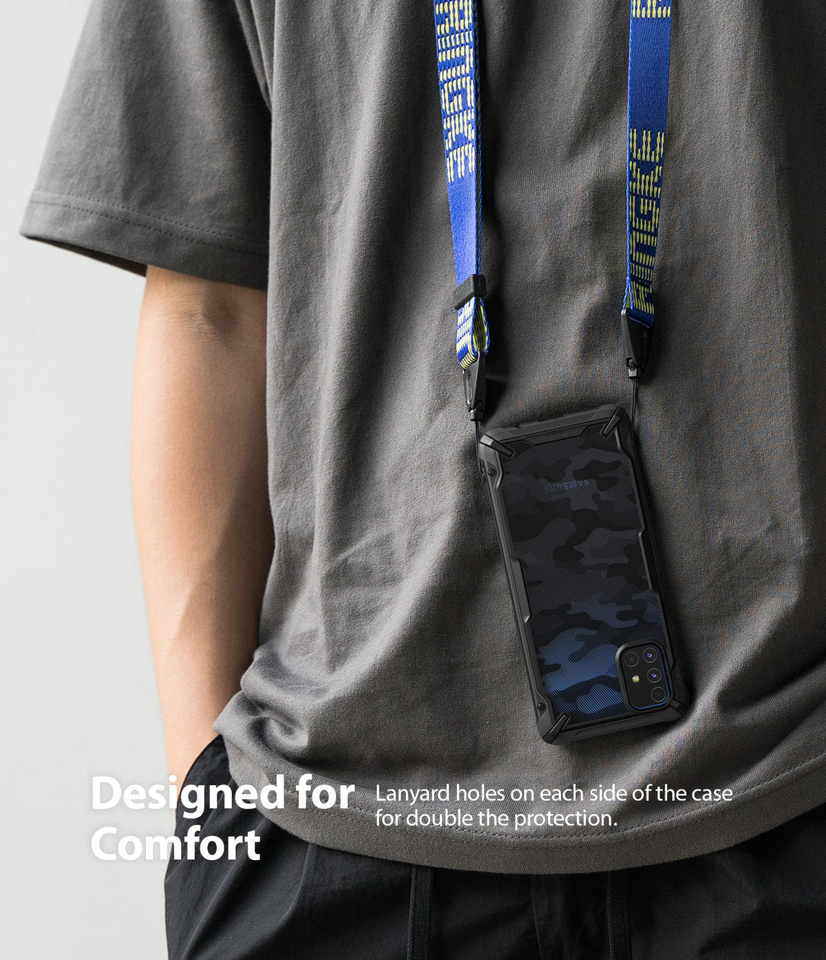 Galaxy M51 Case | Fusion-X - A phone in a blue camo case hanging from a blue branded lanyard around a person's neck.