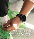 Forerunner 965 | Bezel Styling & Band - Forerunner 965 - A person tying neon green running shoes while wearing a black Garmin watch with a textured fabric band.