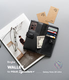 Galaxy Note 20 Ultra Case | Folio Signature+ - Black leather wallet case holding cards and cash, with glasses nearby.