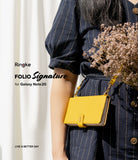 Galaxy Note 20 Case | Folio Signature Yellow - A person wearing a navy striped dress holds a bright yellow folio phone case.
