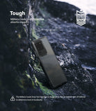 Galaxy S20 Ultra Case | Fusion - A phone in a clear protective case resting against dark, rugged rocks with military-grade certification.