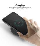 Galaxy S20 Ultra Case | Fusion - Hand placing a phone in a clear case onto a wireless charging pad showing 100% charge.