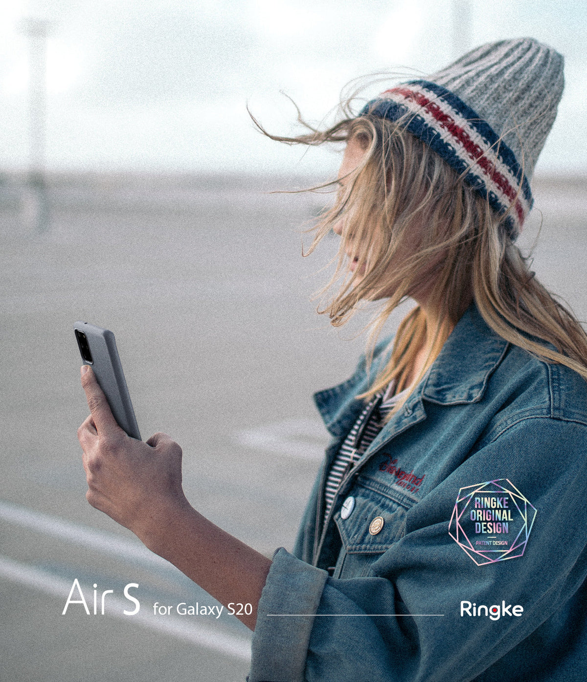 Galaxy S20 Case | Air-S - Woman in a beanie and denim jacket holding a grey Galaxy S20 phone outdoors.