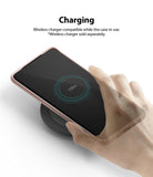 Galaxy S20 Case | Air-S - A hand places a rose gold Galaxy S20 on a wireless charging pad showing a 100% battery icon.