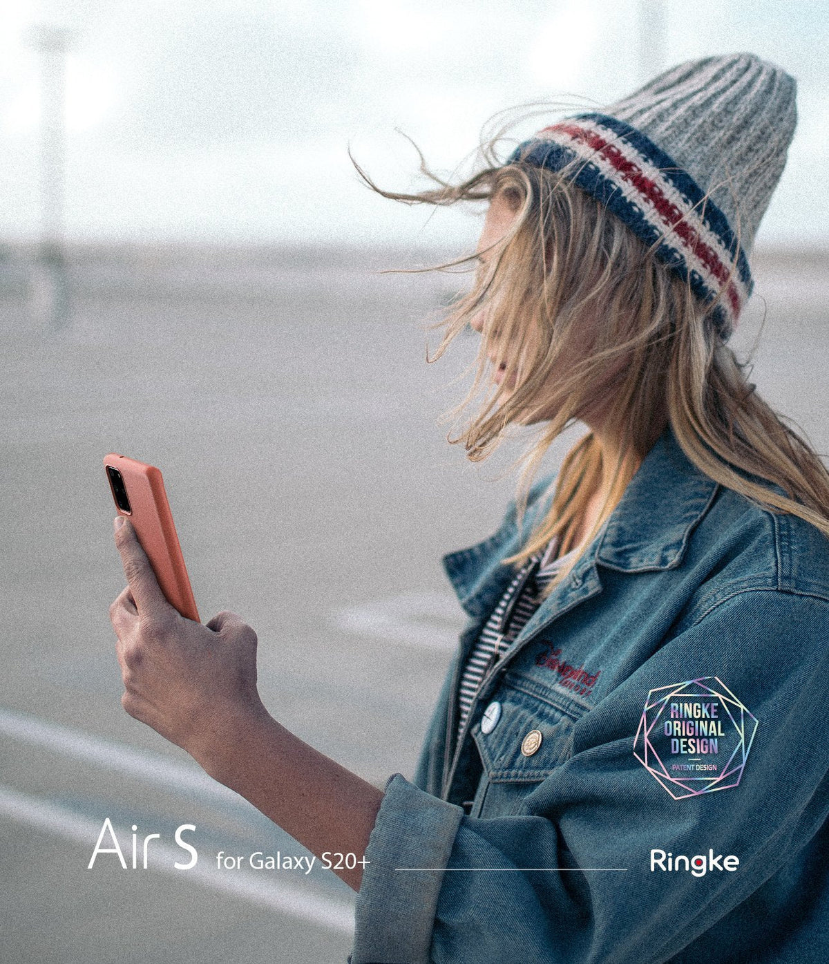 Galaxy S20 Plus Case | Air-S - A woman in a beanie and denim jacket holds a coral-colored Galaxy S20 Plus in a slim case.