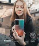 Galaxy S20 Plus Case | Fusion Design - Woman holding a phone with a gradient teal and orange case featuring text.