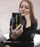 Galaxy S20 Plus Case | Fusion Design - Woman holding a Galaxy S20 Plus in a clear case with a black and neon green sticker.