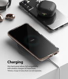Galaxy S21 Plus Case | Air - A clear phone case on a wireless charger showing 100% battery, with earbuds on a second phone.