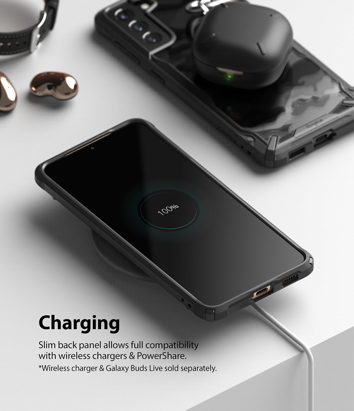 Galaxy S21 Plus Case | Fusion-X - A phone in a black case charging wirelessly with earbuds resting on a second phone.