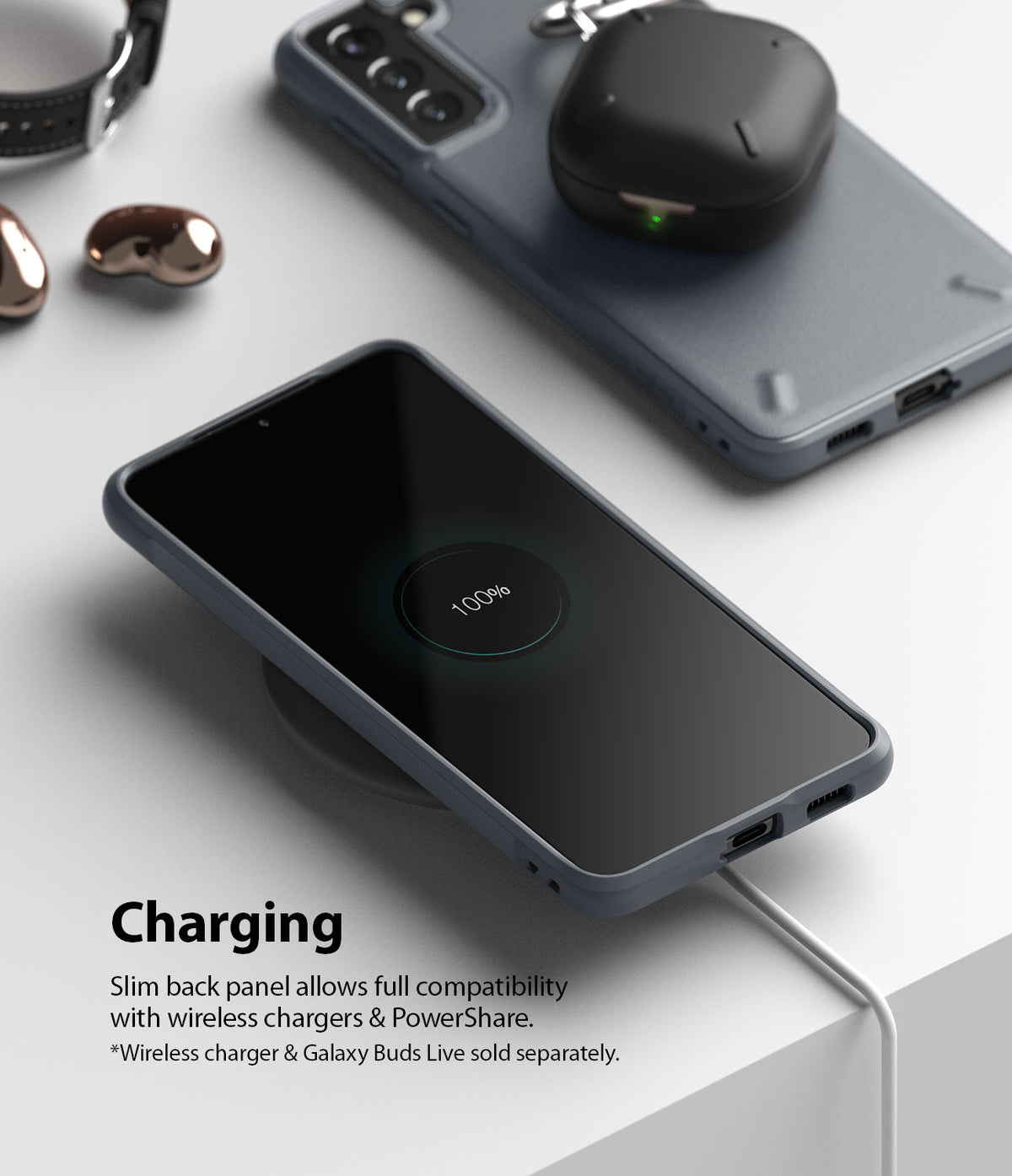 Galaxy S21 Plus Case | Onyx - A smartphone in an Onyx case charging wirelessly, with earbuds charging on a second phone.