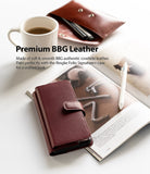 Galaxy S21 Plus Case | Folio Signature+ - Maroon leather folio phone case on an open book with a coffee mug and pen.