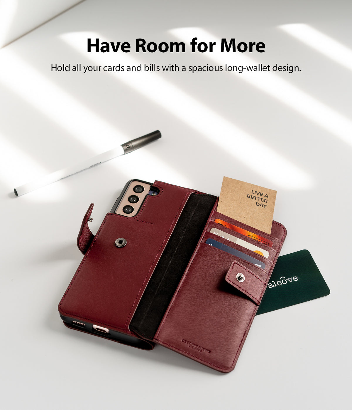 Galaxy S21 Case | Folio Signature+ - Open burgundy leather wallet case holding cards and bills on a white surface.