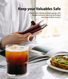 Galaxy S21 Case | Folio Signature+ - Person holding a maroon leather folio phone case with a snap-button closure.