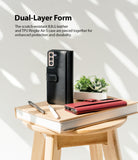 Galaxy S21 Plus Case | Folio Signature+ - Black and red leather folio cases on a book atop a wooden stool with pens.