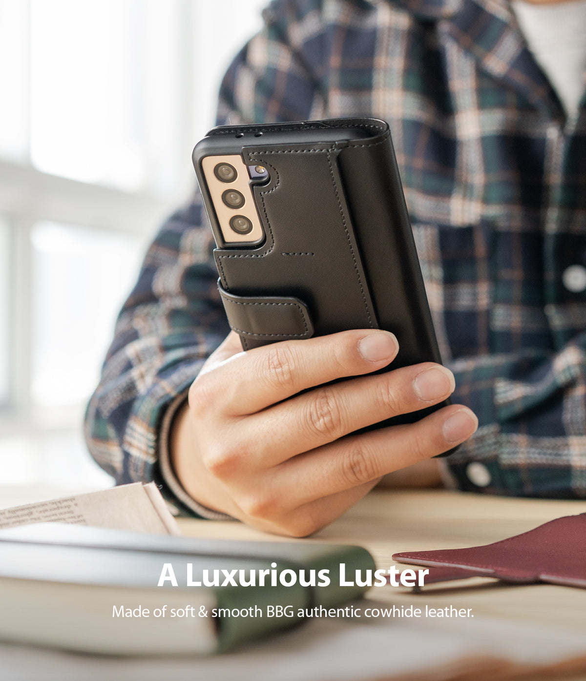 Galaxy S21 Plus Case | Folio Signature+ - Hand holding a black leather folio case on a Galaxy S21 Plus smartphone.