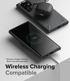 Galaxy S22 Ultra Case Combo | Onyx + Screen Protector - Black phone case on a wireless charger with earbuds on top.