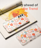 Galaxy S22 Case | Fusion Design - Two clear phone cases with colorful floral patterns resting on a floral magazine.