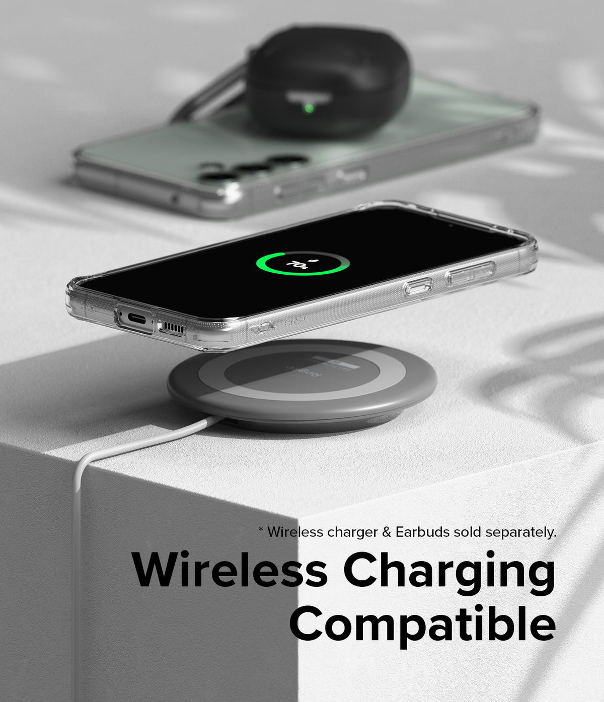 Galaxy S23 FE Case | Fusion - A clear phone case on a wireless charging pad showing a 70% charge icon on the screen.