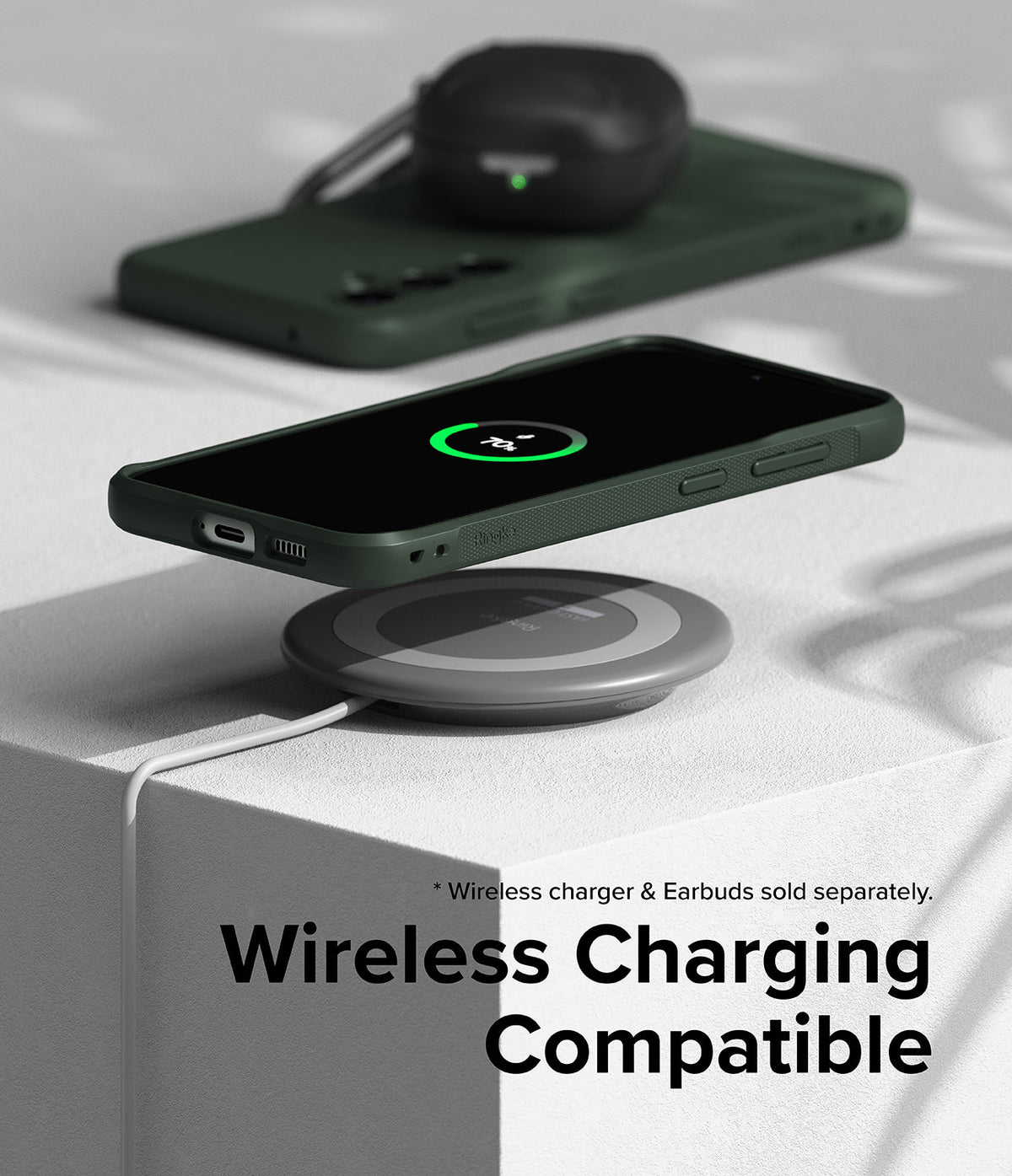 Galaxy S23 FE Case | Onyx - Dark green phone case on a wireless charging pad with a 70% charge icon on the screen.