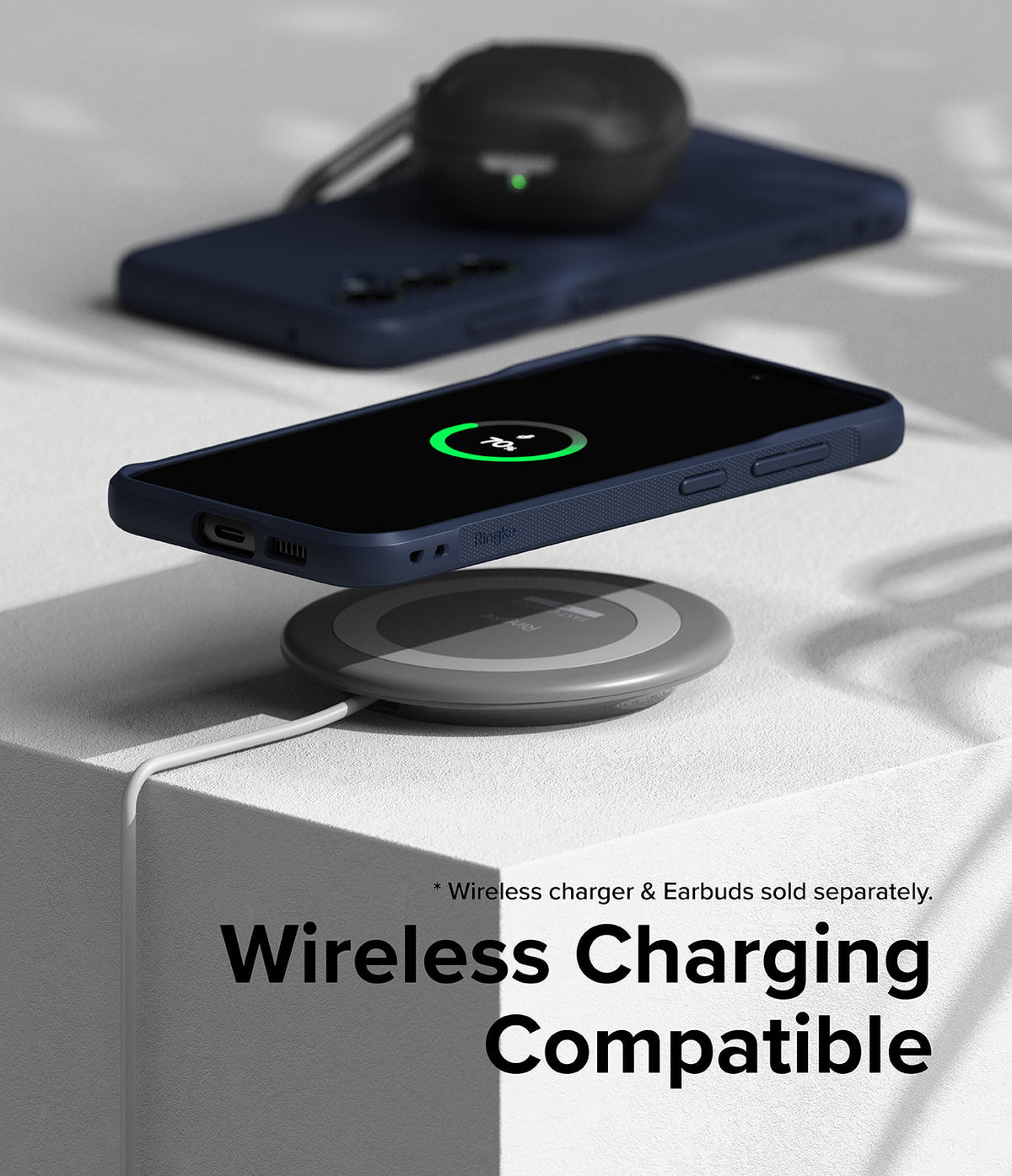 Galaxy S23 FE Case | Onyx - Navy phone case on a wireless charging pad with a 70% battery icon displayed on the screen.