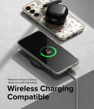Galaxy S23 Plus Case | Fusion Design - Floral phone case on a wireless charger with a charging phone and earbuds.