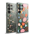 Galaxy S23 Ultra Case | Fusion Design - Two clear phone cases featuring colorful, artistic floral patterns on a green background.