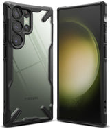 Galaxy S23 Ultra Case | Fusion-X - Front and back view of a rugged black phone case on a green Samsung Galaxy S23 Ultra.