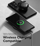 Galaxy S23 Ultra Case | Onyx - Black phone case on a wireless charger showing 70% charge with earbuds resting on top.