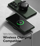 Galaxy S23 Ultra Case | Onyx - Green phone case on a wireless charger with charging screen and black earbuds case on top.