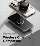 Galaxy S23 Case | Fusion Design - Clear floral phone case on a wireless charger with a charging phone and earbuds case.
