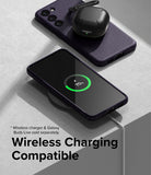 Galaxy S23 Case | Onyx - A dark purple Galaxy S23 case on a wireless charger with a charging phone and earbuds case nearby.