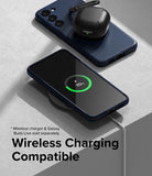 Galaxy S23 Plus Case | Onyx - A navy phone case on a wireless charger with a charging phone and earbuds case on top.