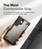 Galaxy S24 Ultra Case | Fusion-X - Hand holding a phone in a black protective case with a textured, dotted side grip.