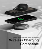 Galaxy S24 Ultra Case | Fusion-X - Galaxy S24 Ultra in a black case wirelessly charging on a pad with earbuds in the background.