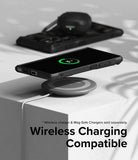 Galaxy S24 Ultra Case | Fusion-X - Phone in a black case wirelessly charging on a pad with earbuds in the background.
