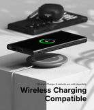 Galaxy S24 Ultra Case | Onyx Design - Black phone in Onyx case wirelessly charging on a pad with earbuds in the background.