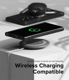 Galaxy S24 Ultra Case | Onyx Design - Smartphone in black case wirelessly charging on a circular pad with earbuds nearby.