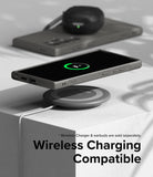 Galaxy S24 Ultra Case | Onyx - Smartphone in an onyx case wirelessly charging on a pad with earbuds in the background.