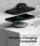 Galaxy S24 Case | Fusion-X - Galaxy S24 in a black case wirelessly charging on a pad with earbuds in the background.