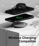 Galaxy S24 Case | Fusion-X - A Galaxy S24 in a black case wirelessly charging on a pad with earbuds in the background.