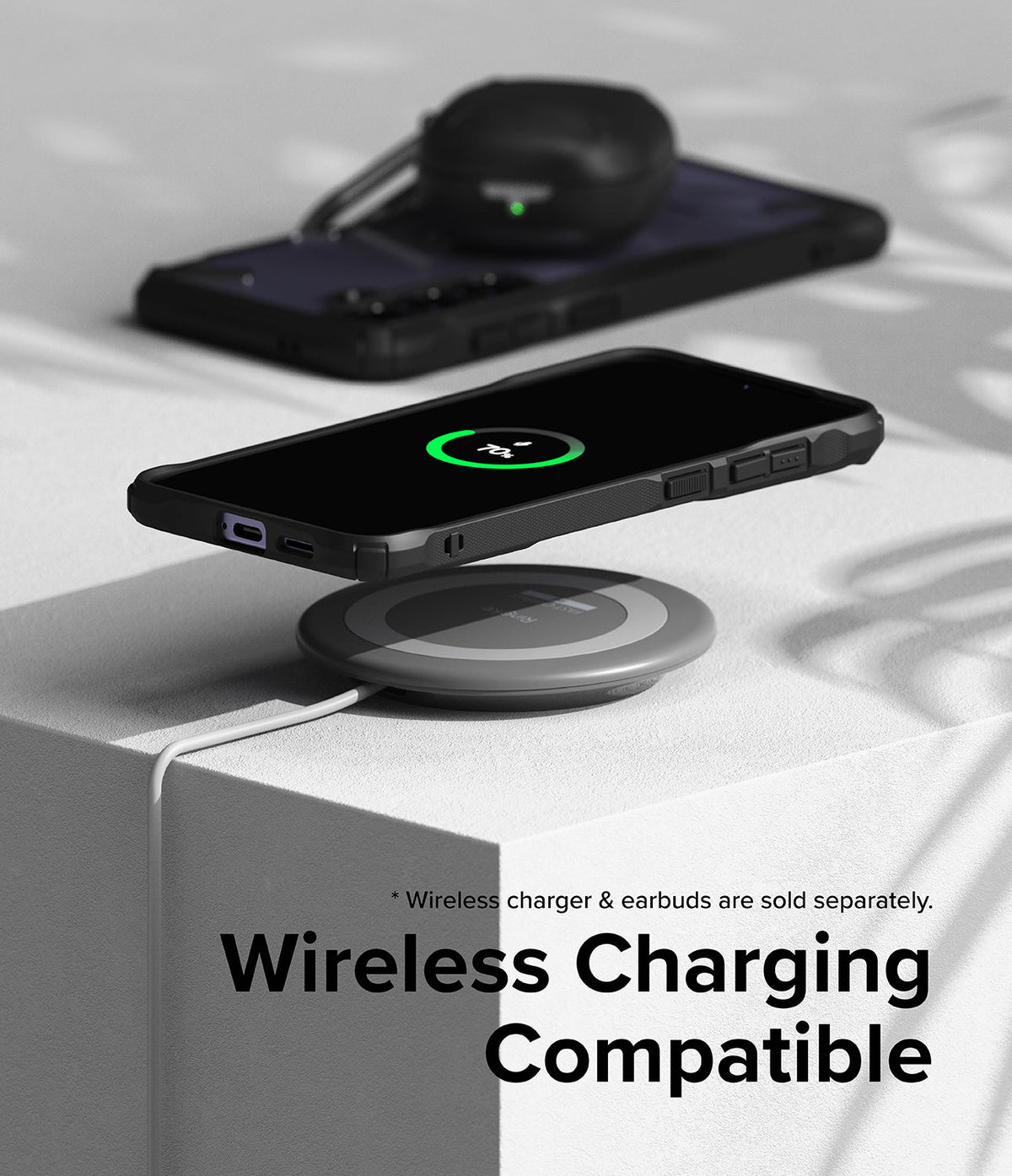 Galaxy S24 Plus Case | Fusion-X - Black phone case on a wireless charging pad showing a 70% charge icon on the screen.